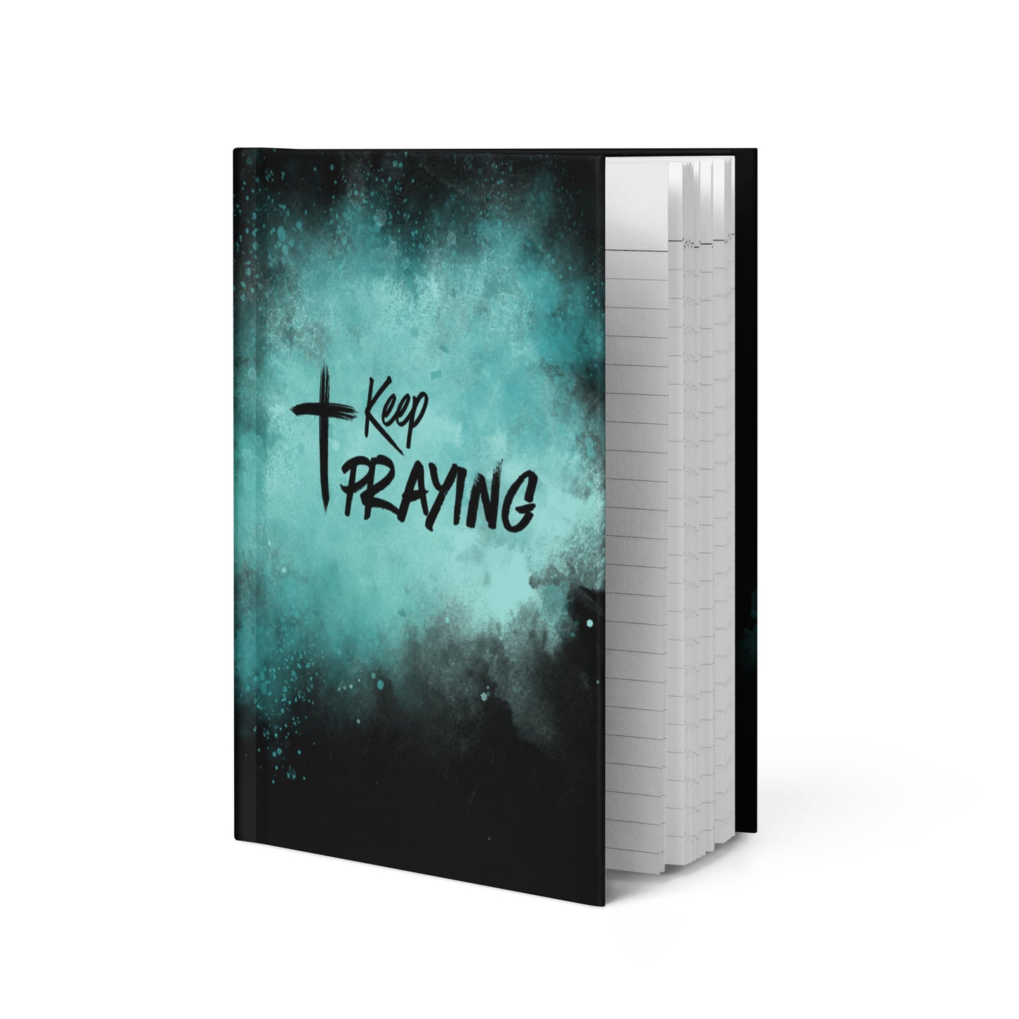 A notebook with a black and teal watercolor cover featuring the text 'Keep PRAYING' with a cross symbol, shown standing upright against a white background.