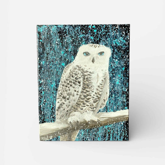 A vertical canvas oil painting featuring a snowy owl perched on a branch against a textured teal and black background, shown standing against a light gray studio backdrop.