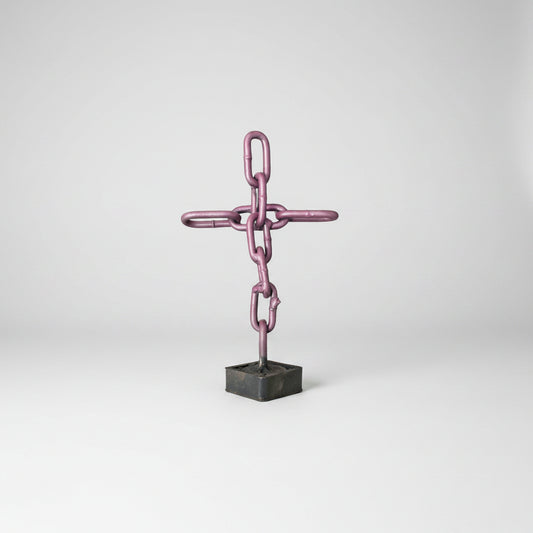 Purple scrap metal cross made of chain link chains. 