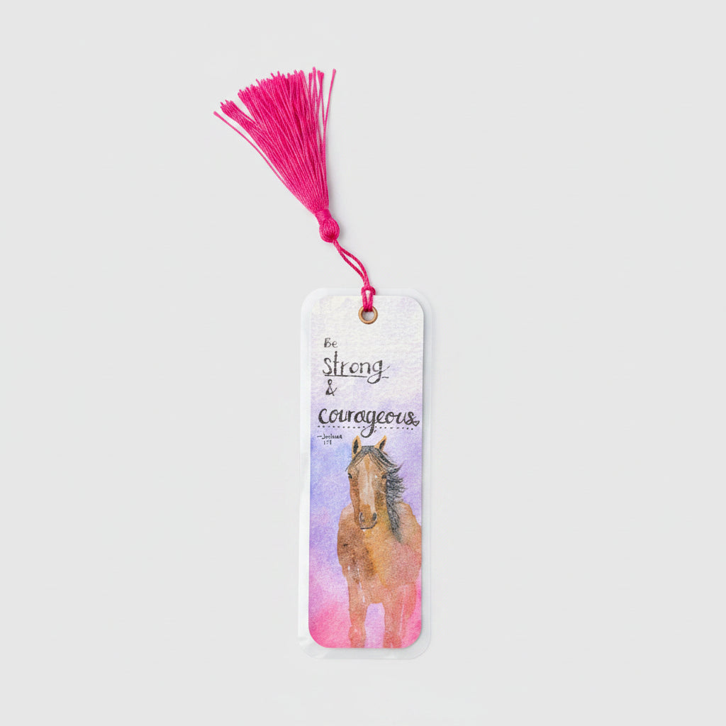 A rectangular bookmark with a bright pink tassel, featuring a watercolor illustration of a brown horse and the words 'Be strong & courageous'.