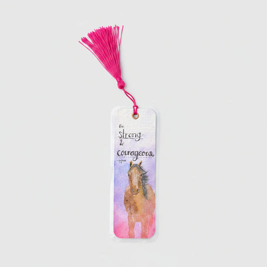 A rectangular bookmark with a bright pink tassel, featuring a watercolor illustration of a brown horse and the words 'Be strong & courageous'.